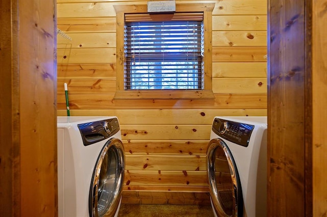 laundry area featuring washer and dryer and wooden walls