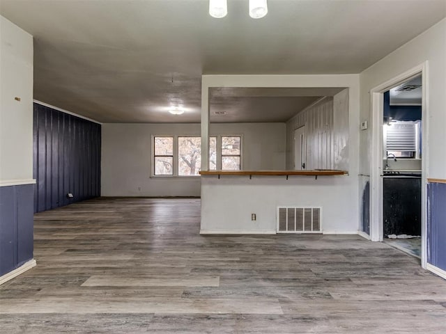 unfurnished living room featuring hardwood / wood-style flooring