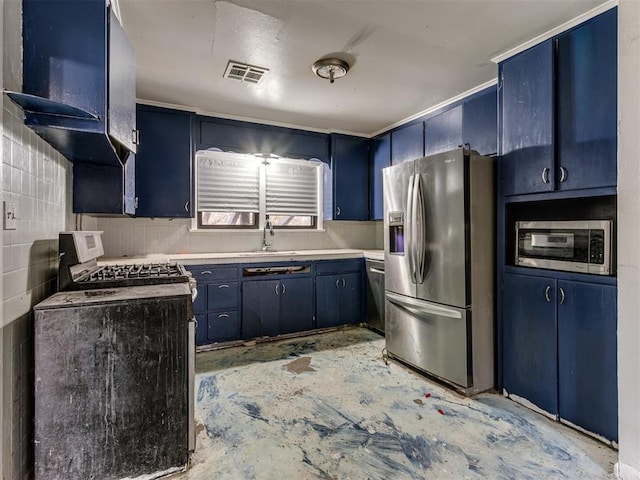 kitchen featuring sink, blue cabinets, tile walls, and appliances with stainless steel finishes