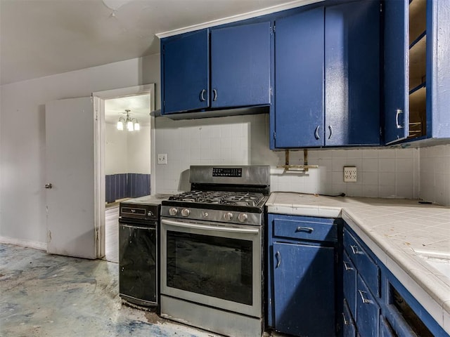 kitchen with stainless steel gas stove, tile counters, an inviting chandelier, blue cabinets, and decorative backsplash