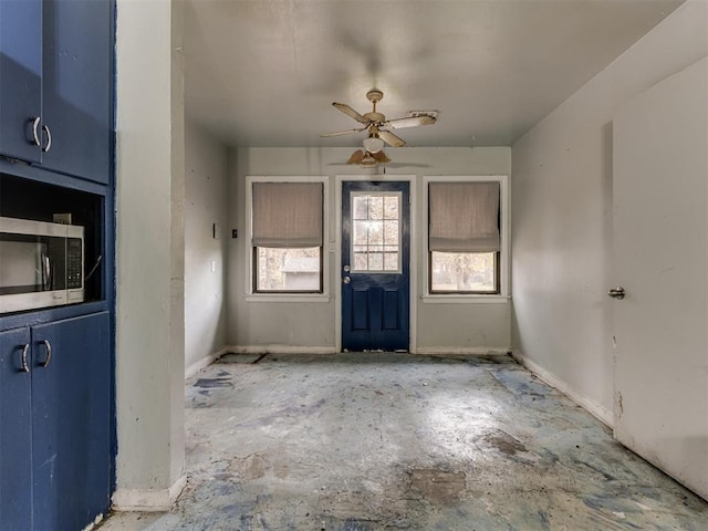 interior space with ceiling fan