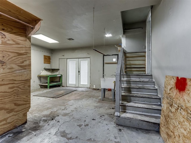 interior space featuring concrete floors, sink, and french doors