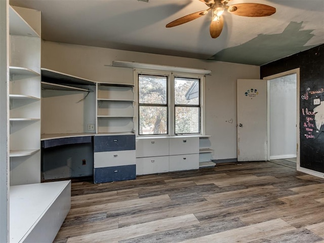 interior space with dark hardwood / wood-style flooring and ceiling fan