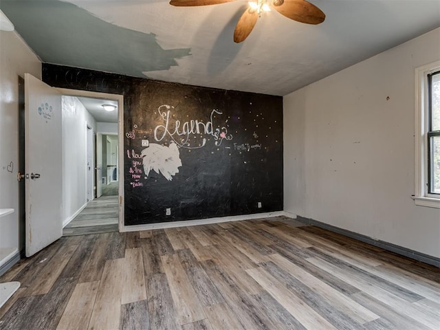 empty room with wood-type flooring and ceiling fan