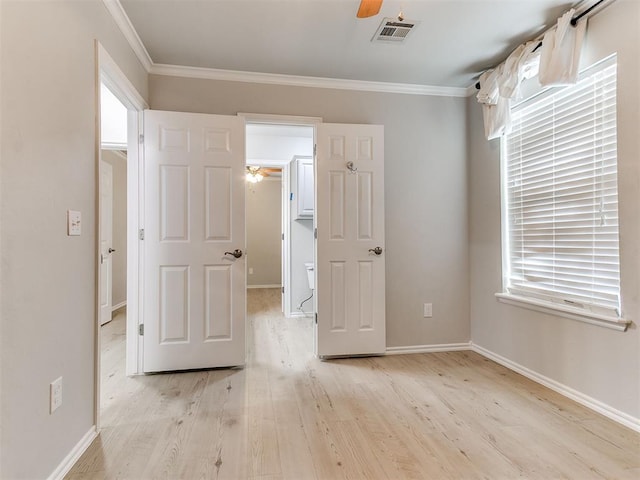 unfurnished bedroom with light hardwood / wood-style floors, ceiling fan, and crown molding