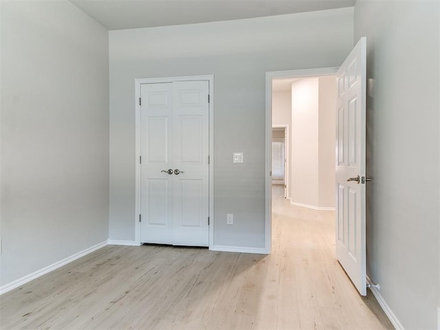 unfurnished bedroom with light wood-type flooring