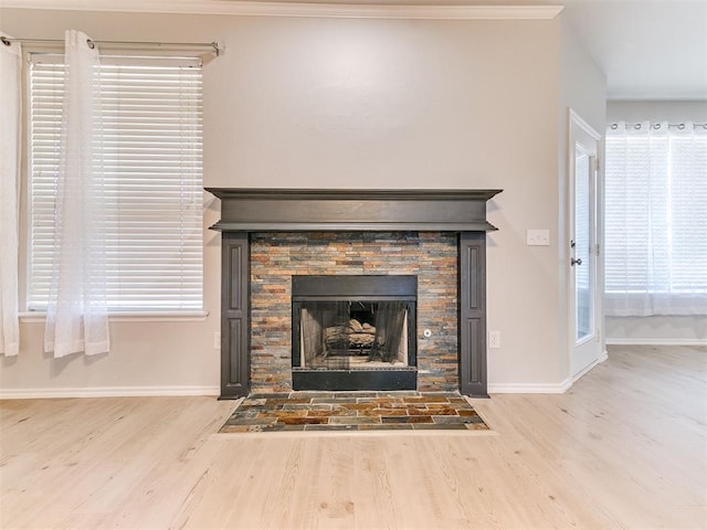 details featuring hardwood / wood-style flooring, ornamental molding, and a fireplace