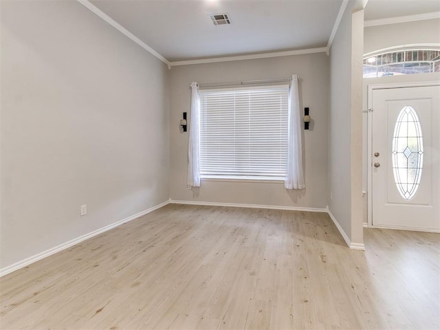 foyer entrance with crown molding and light wood-type flooring