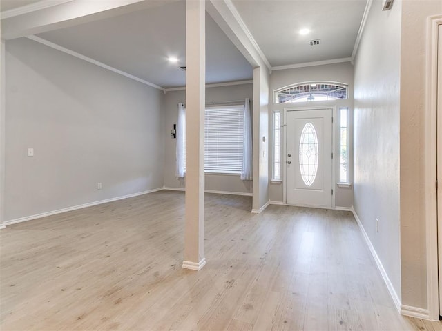 foyer entrance with light wood-type flooring and ornamental molding