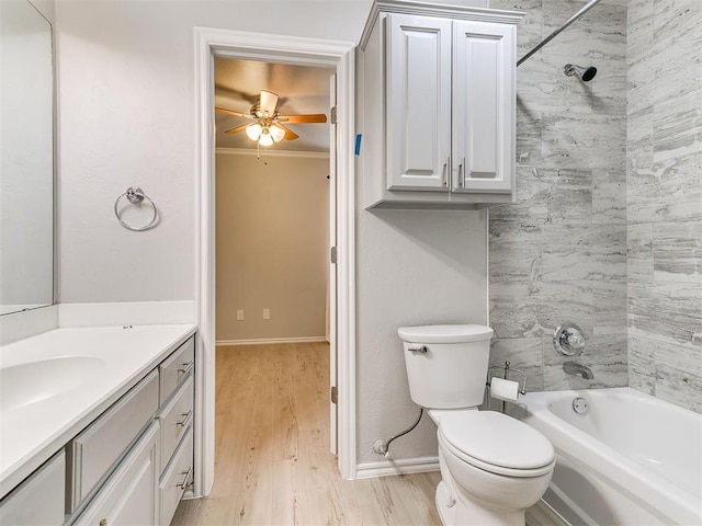 full bathroom with tiled shower / bath combo, toilet, hardwood / wood-style flooring, vanity, and ornamental molding