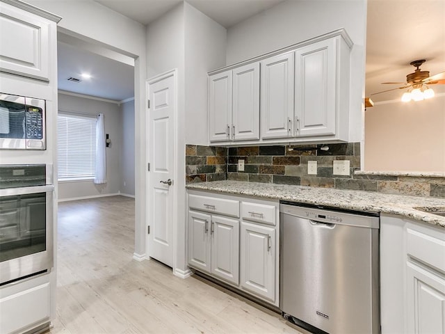 kitchen with white cabinetry, light hardwood / wood-style flooring, ornamental molding, and appliances with stainless steel finishes