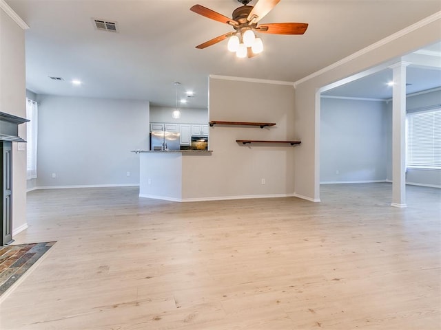 unfurnished living room featuring ceiling fan, light wood-type flooring, crown molding, and a wealth of natural light