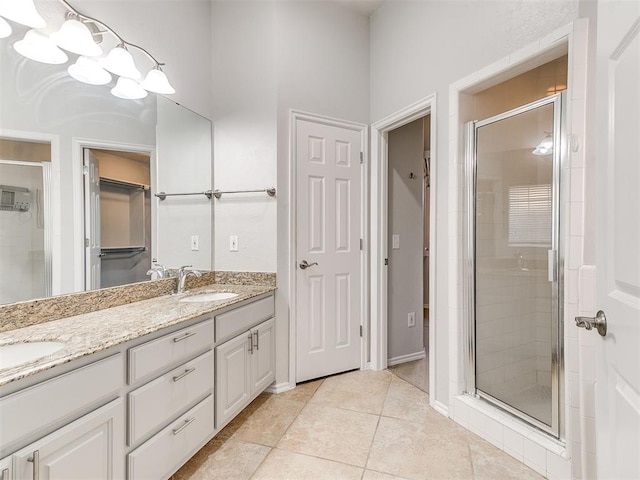 bathroom with tile patterned floors, vanity, and an enclosed shower