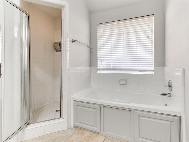 bathroom featuring tile patterned flooring and separate shower and tub