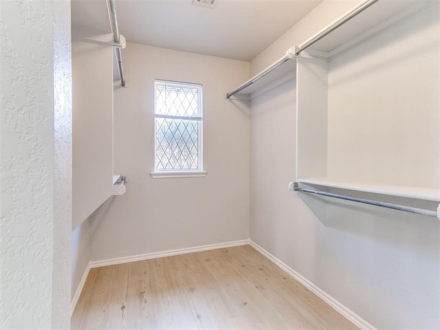 spacious closet featuring light hardwood / wood-style flooring