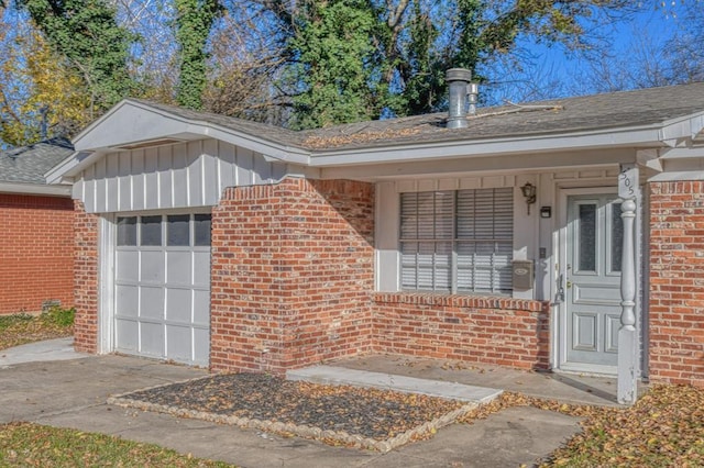 view of exterior entry featuring covered porch and a garage