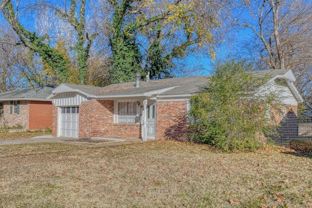 single story home featuring a front lawn and a garage