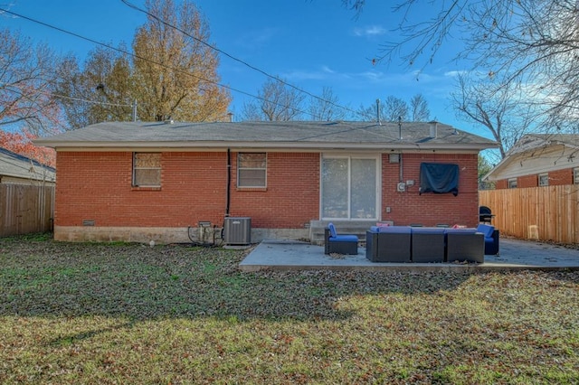 back of house featuring outdoor lounge area, a patio, central AC, and a lawn