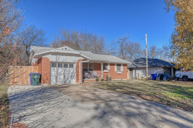 single story home featuring a front yard and a garage