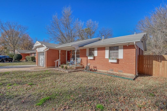 ranch-style house with a garage and a front lawn