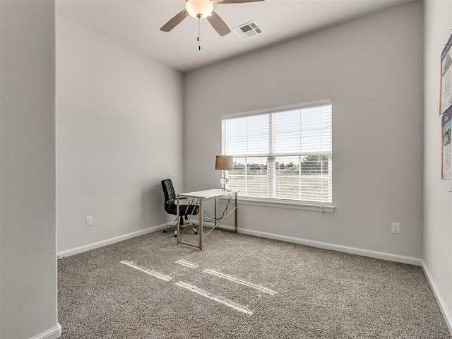 unfurnished office featuring carpet flooring and ceiling fan