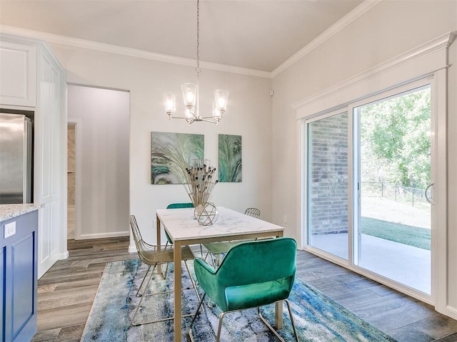 dining room with crown molding, wood-type flooring, and a notable chandelier