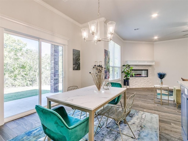 dining space featuring ornamental molding, ceiling fan with notable chandelier, and hardwood / wood-style flooring