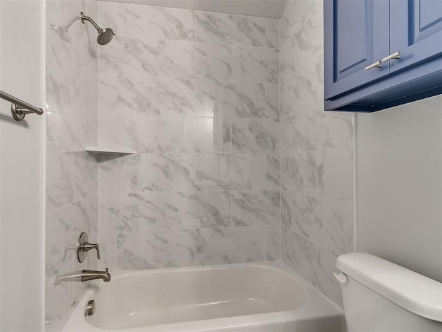 bathroom with tiled shower / bath combo and toilet