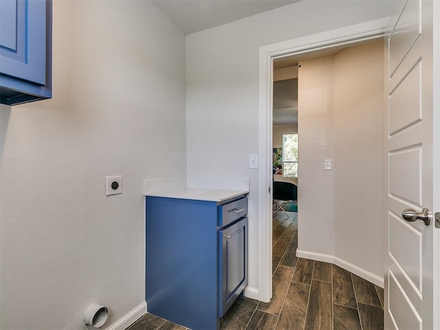 washroom featuring dark hardwood / wood-style flooring and hookup for an electric dryer