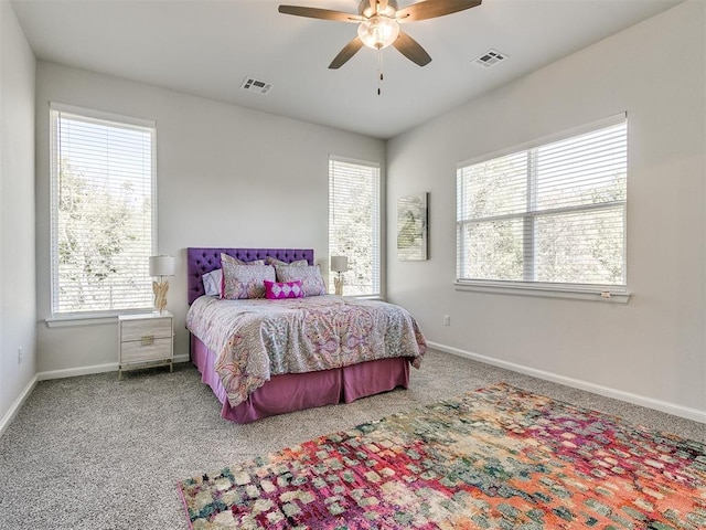 bedroom featuring multiple windows, ceiling fan, and carpet