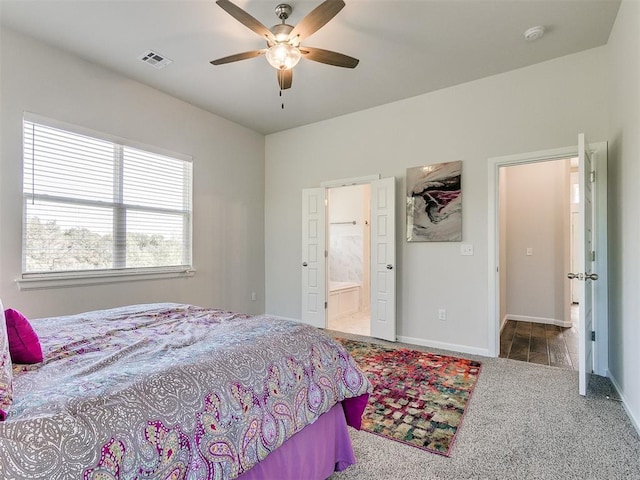 bedroom featuring carpet, ensuite bathroom, and ceiling fan