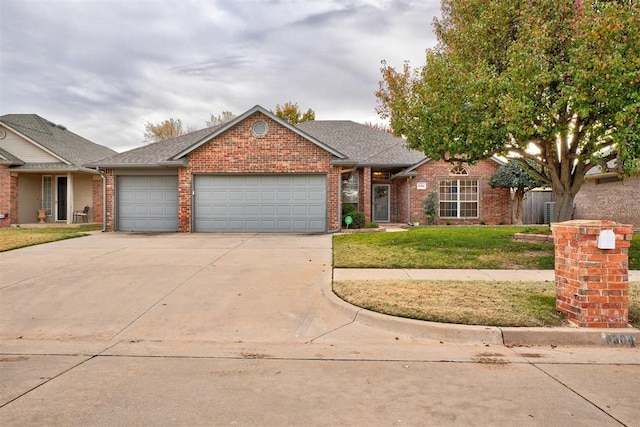 ranch-style home featuring a garage and a front lawn