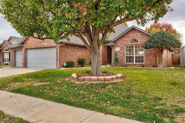 view of front of property with a front yard and a garage