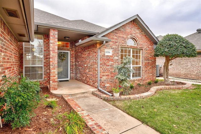 view of exterior entry featuring a yard