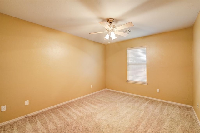 empty room featuring carpet flooring and ceiling fan