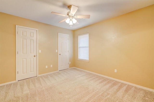 unfurnished bedroom with light colored carpet and ceiling fan