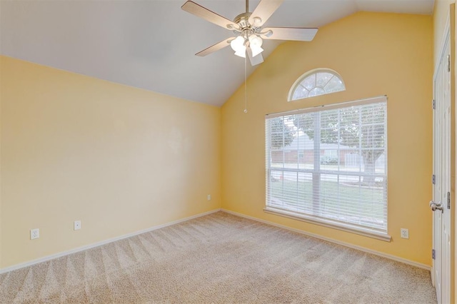 spare room with light carpet, vaulted ceiling, and ceiling fan