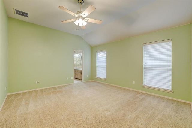 carpeted empty room with ceiling fan and vaulted ceiling