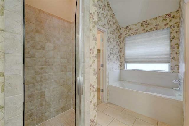 bathroom with tile patterned flooring and shower with separate bathtub