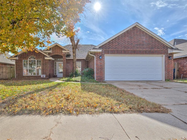 view of front of property with a garage and a front lawn