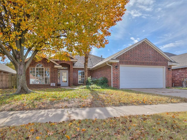 1036 SW 129th St, Moore, OK 73170 - view of front of property featuring an attached garage, brick siding, driveway, and a shingled roof