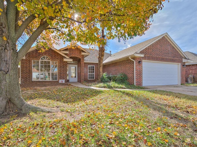 1036 SW 129th St, Moore, OK 73170 - traditional home with brick siding, a garage, roof with shingles, and driveway