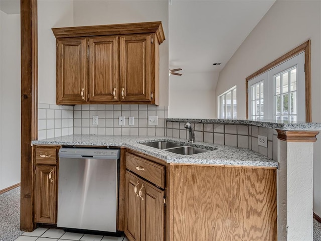 1036 SW 129th St, Moore, OK 73170 - kitchen with dishwasher, a peninsula, light stone counters, decorative backsplash, and brown cabinetry