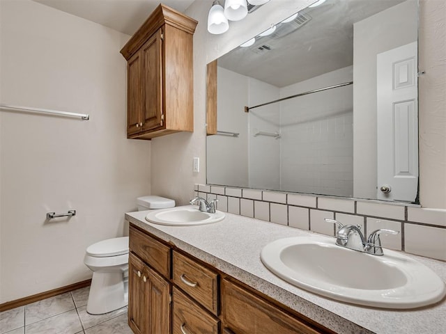 bathroom featuring tile patterned floors, decorative backsplash, toilet, and vanity