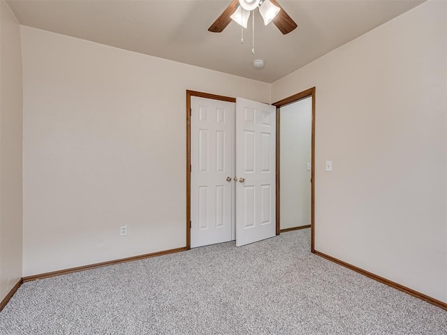 unfurnished bedroom with a closet, light colored carpet, and ceiling fan