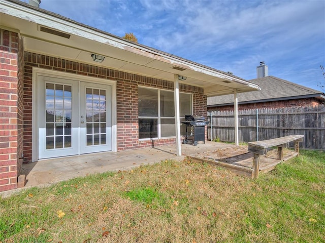 1036 SW 129th St, Moore, OK 73170 - rear view of property featuring brick siding, french doors, and a patio