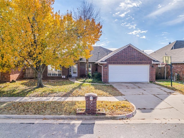 1036 SW 129th St, Moore, OK 73170 - view of front facade featuring brick siding, a garage, and concrete driveway