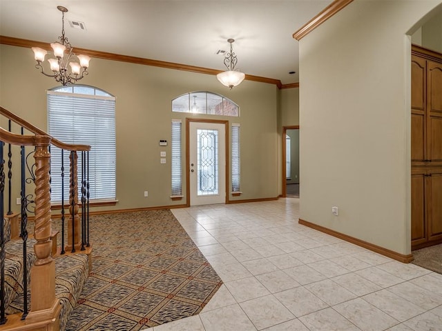 tiled entrance foyer with an inviting chandelier, plenty of natural light, and crown molding