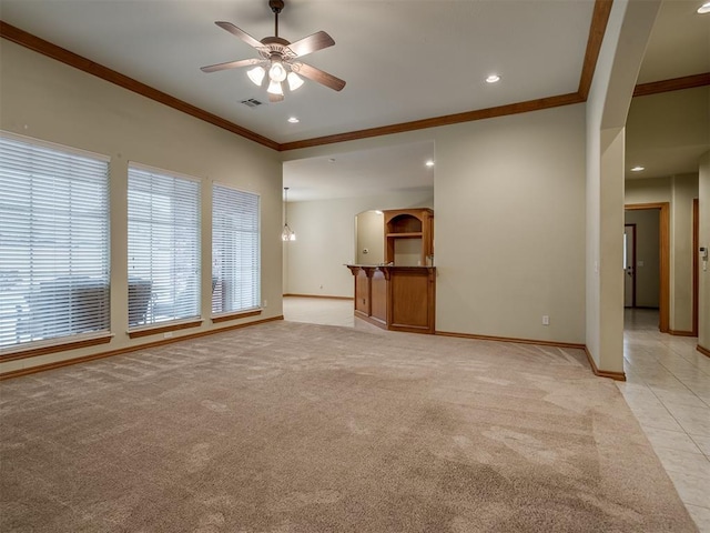 unfurnished living room featuring ceiling fan, light colored carpet, and ornamental molding