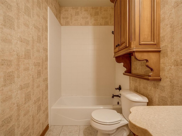 bathroom featuring tile patterned flooring, shower / bathtub combination, and toilet